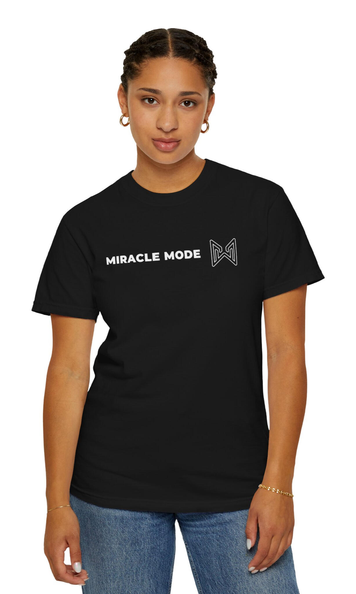 Woman wearing a black MERAQL Miracle Mode T-shirt with horizontal white text and an outlined emblem across the center chest.