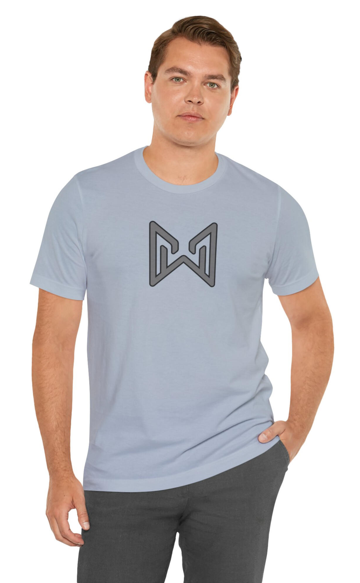 Model wearing a light blue MERAQL Emblem Tee with a gray geometric emblem on the chest.